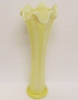 A yellow vase with a white top

AI-generated content may be incorrect.