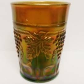 A glass with grapes on it

AI-generated content may be incorrect.