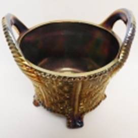 A gold bowl with handles

AI-generated content may be incorrect.