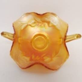 A yellow glass vase with a handle

AI-generated content may be incorrect.