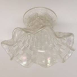 A clear glass vase with a ruffled edge

AI-generated content may be incorrect.