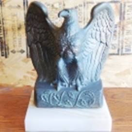 A statue of an eagle on a white block

AI-generated content may be incorrect.