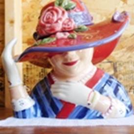 A ceramic statue of a person wearing a hat

AI-generated content may be incorrect.