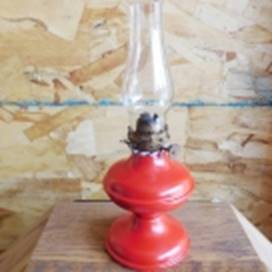 A red oil lamp on a wood surface

AI-generated content may be incorrect.