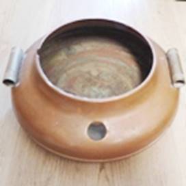 A brown pot with two handles

AI-generated content may be incorrect.
