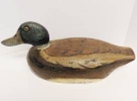A wooden duck on a white surface

AI-generated content may be incorrect.