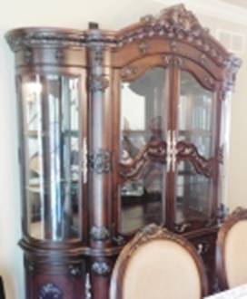 A wooden cabinet with glass doors

AI-generated content may be incorrect.