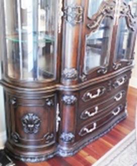 A wooden cabinet with glass doors

AI-generated content may be incorrect.