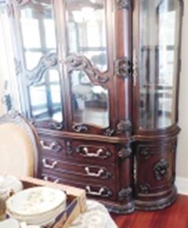 A wooden cabinet with glass doors

AI-generated content may be incorrect.