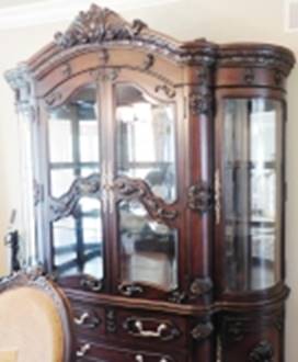 A wooden cabinet with glass doors

AI-generated content may be incorrect.