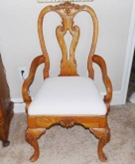 A wooden chair with a white cushion

AI-generated content may be incorrect.