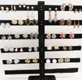 A black stand with earrings on it

AI-generated content may be incorrect.