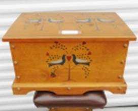 A wooden box with birds painted on it

AI-generated content may be incorrect.