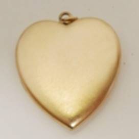A gold heart shaped pendant

AI-generated content may be incorrect.