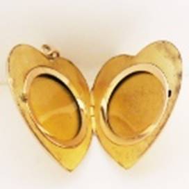 A gold heart shaped locket

AI-generated content may be incorrect.