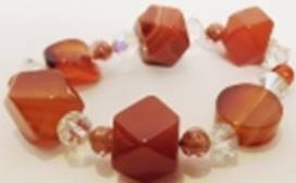 A bracelet with orange stones

AI-generated content may be incorrect.